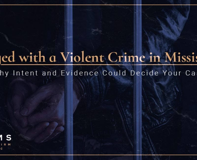 Person in handcuffs behind jail bars symbolizing violent crime charges in Mississippi